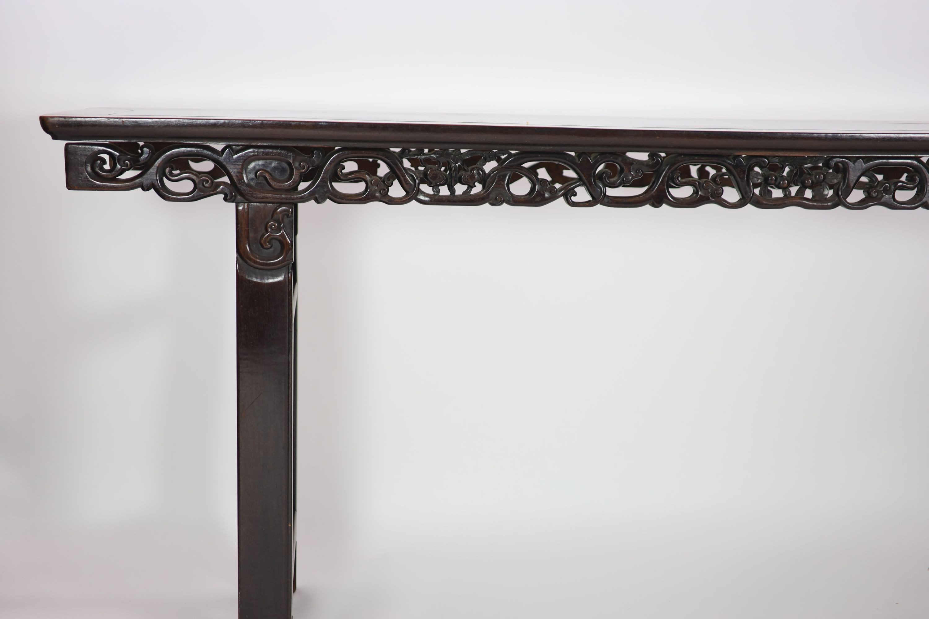 A large Chinese hongmu altar table, 19th century H 110cm. W 281cm. D 51.5cm.
